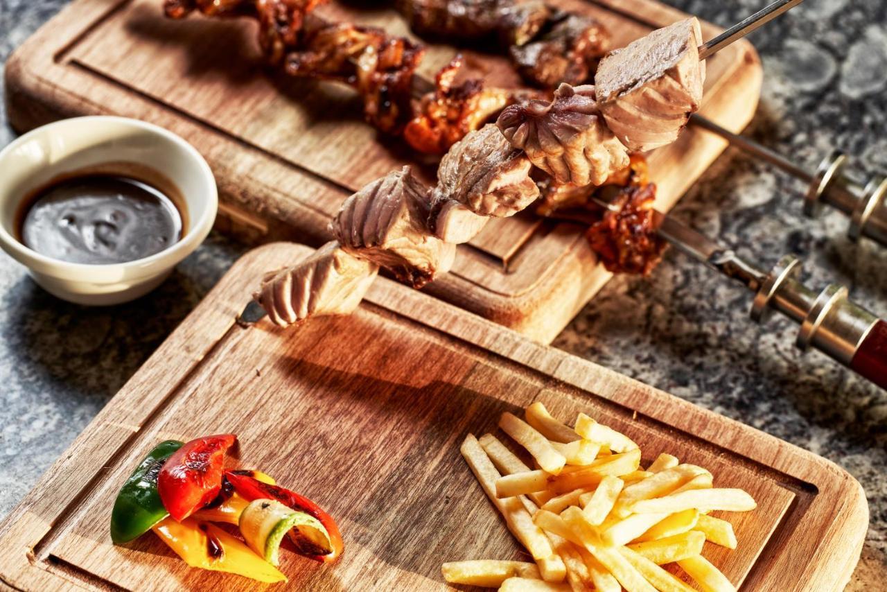 Fanar Hotel & Residences Salalah Exterior photo A wooden cutting board