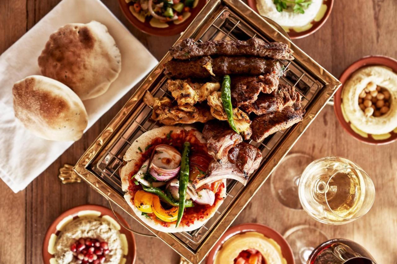 Fanar Hotel & Residences Salalah Exterior photo A selection of Middle Eastern cuisine